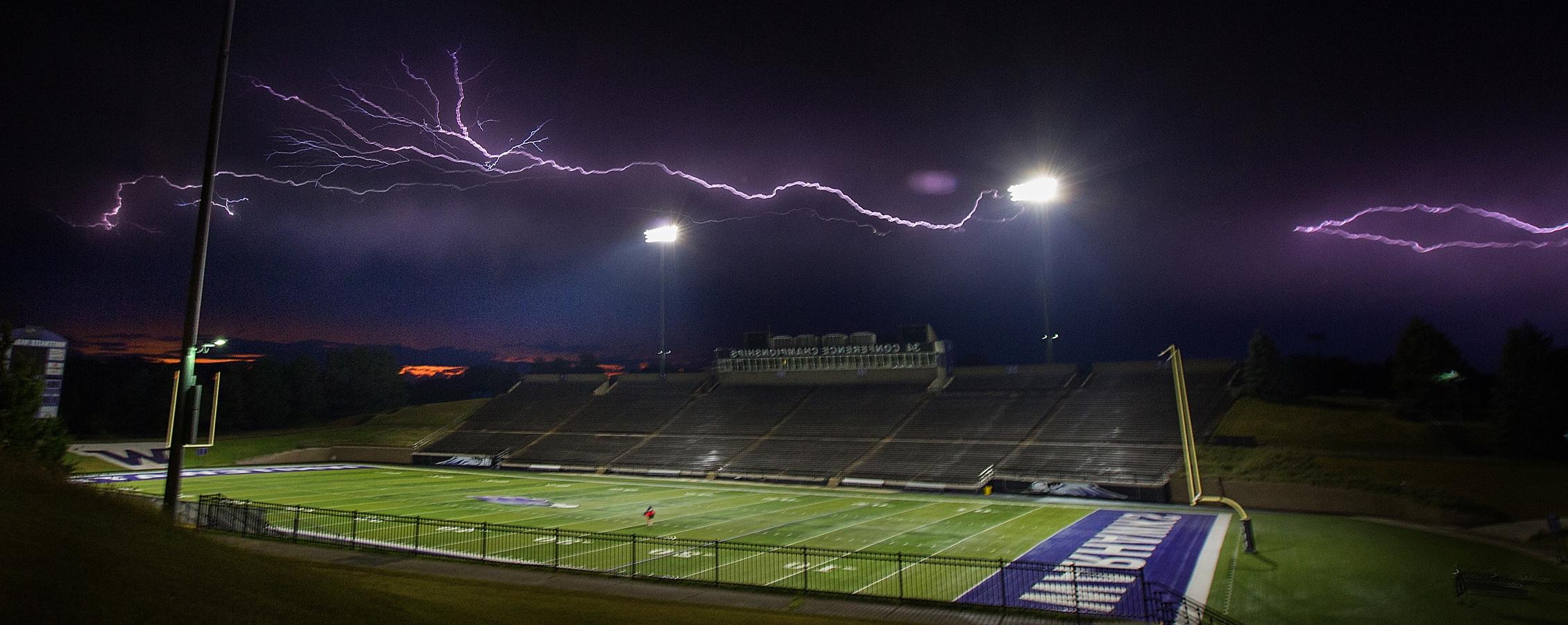 Lightning strikes against a black sky over Perkins stadium.